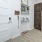 a kitchen with a refrigerator and a shelf